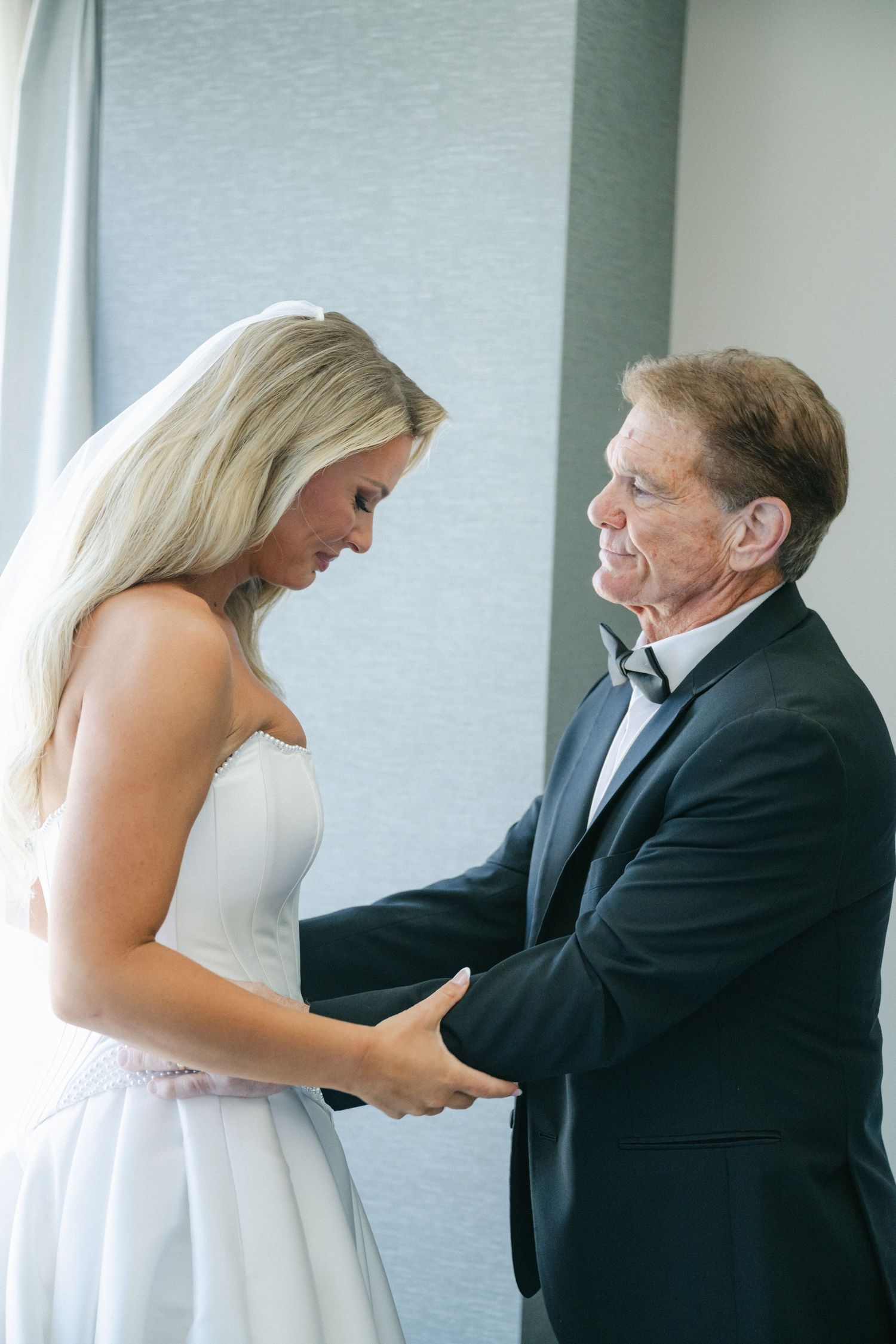 A sequence of wedding preparation photos showing a bride getting help with her dress from an older gentleman in formal attire.