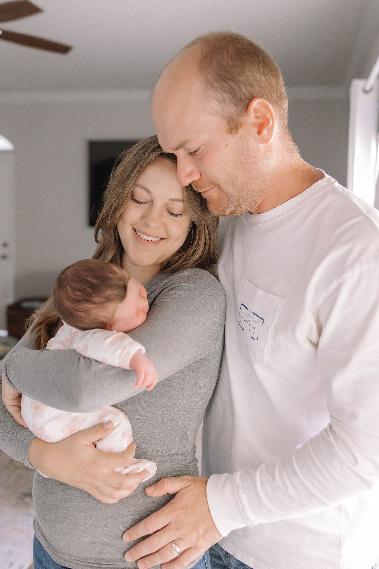 Tender moment between couple embracing while expecting a baby.