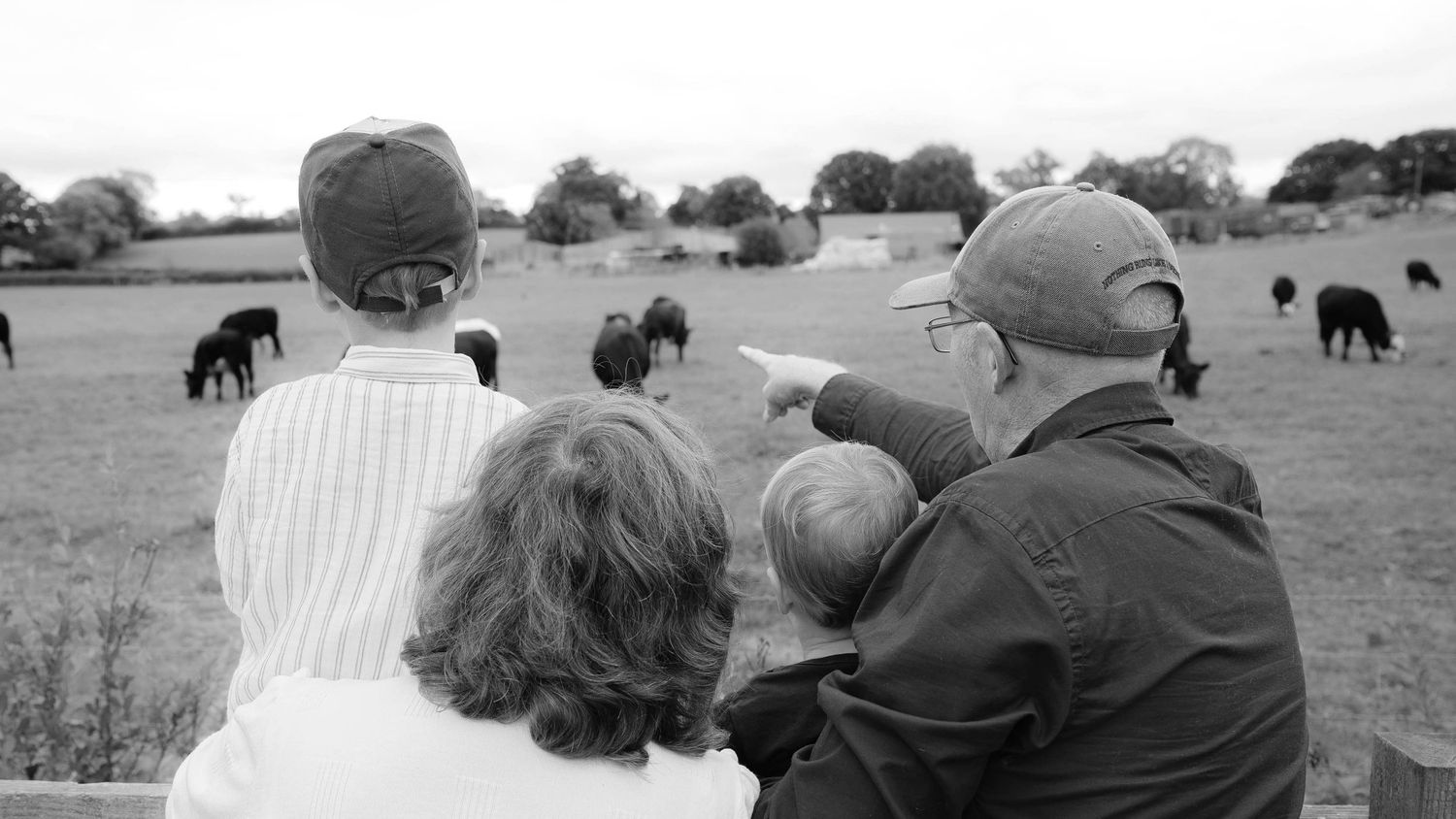 A series of black and white intimate family moments showing tender interactions between parents and baby.