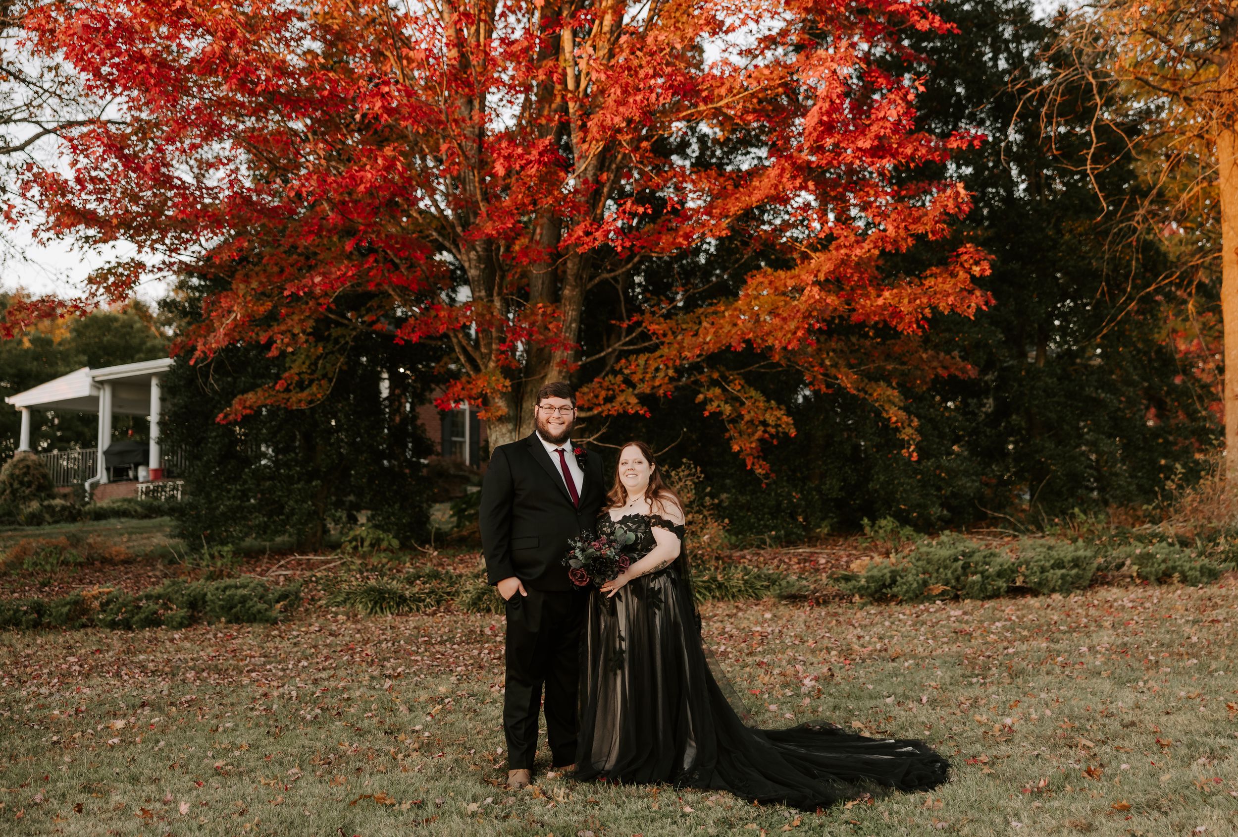 A couple's formal photoshoot set against a backdrop of brilliant fall colors.
