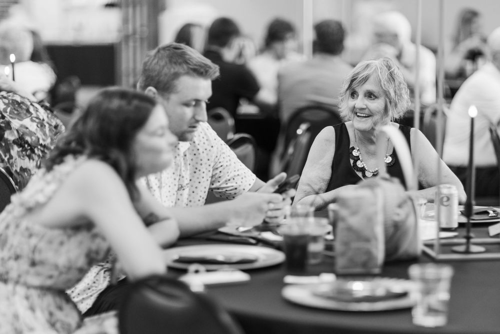 People sitting and dining together at tables in a restaurant or cafeteria setting.