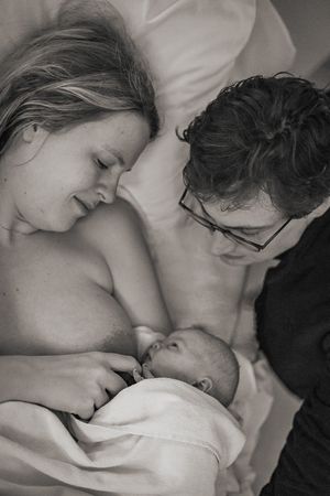Förlossningsfotografering på Akademiska sjukhuset i Uppsala. Bild på föräldrarna och bebis, lugn stund.