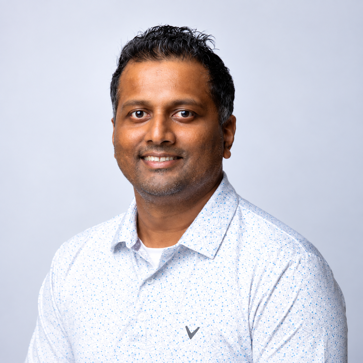 Professional headshot portraits of someone in a black suit and white shirt against a white background.