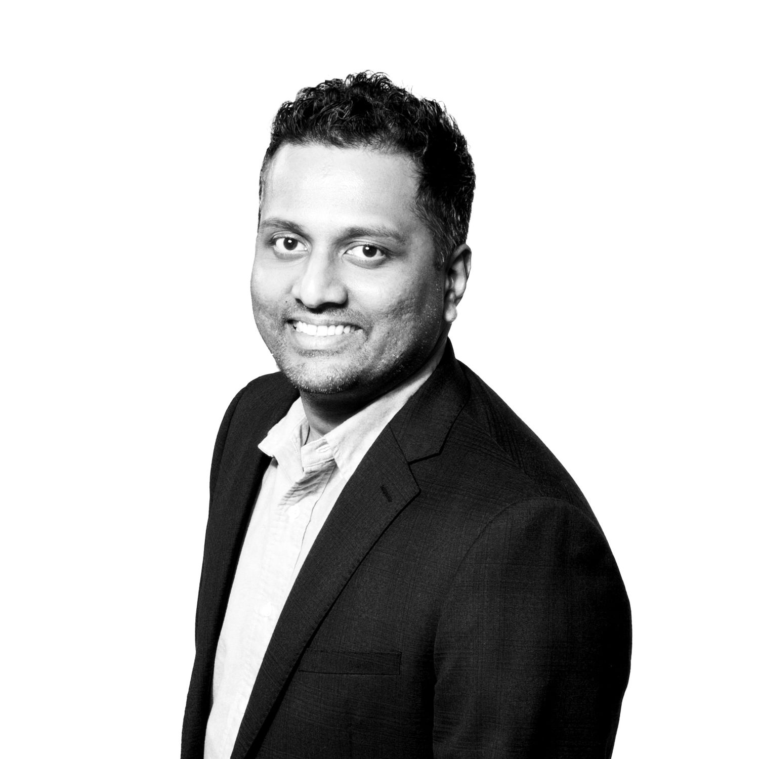 Professional headshot portraits of someone in a black suit and white shirt against a white background.