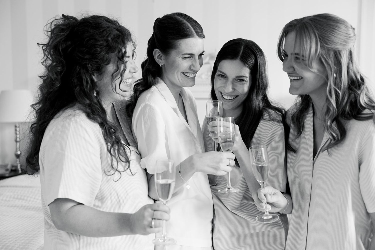 A series of black and white candid photos showing joyful moments and laughter between people in casual settings.