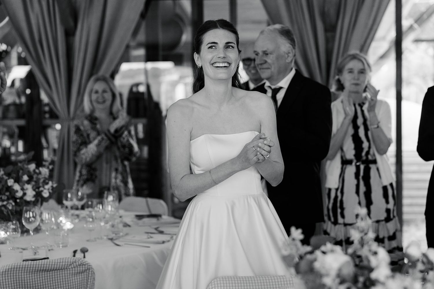 Close-up detail of a white strapless wedding dress bodice showing elegant structured tailoring and fabric draping.