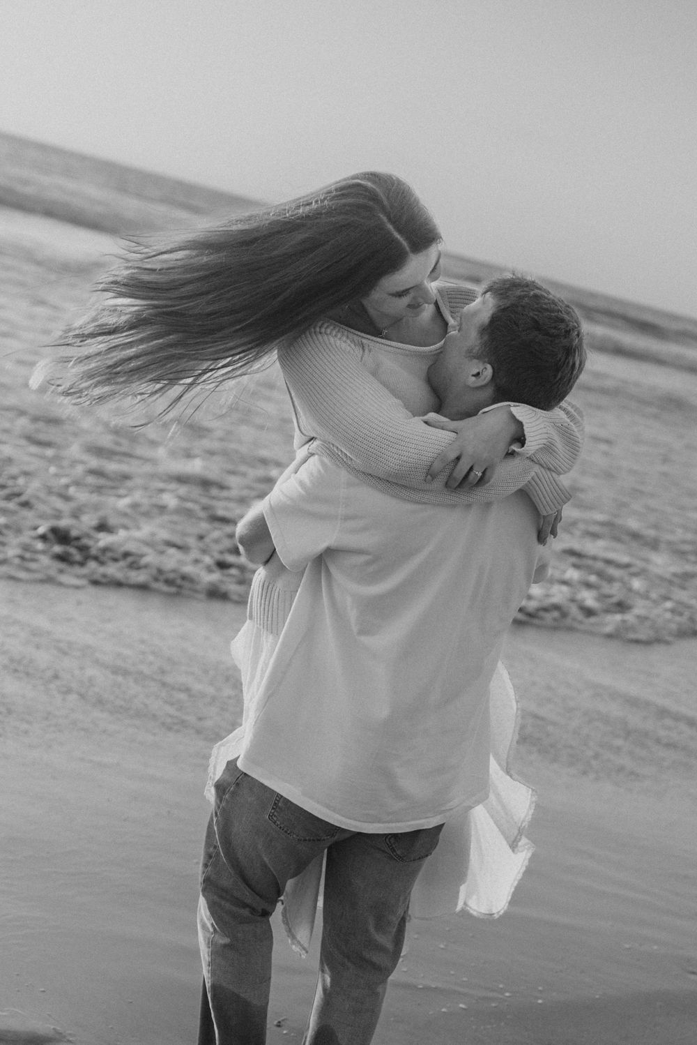 Blacks Beach couples photos with candid movement and dramatic coastal views, San Diego Engagement Photos