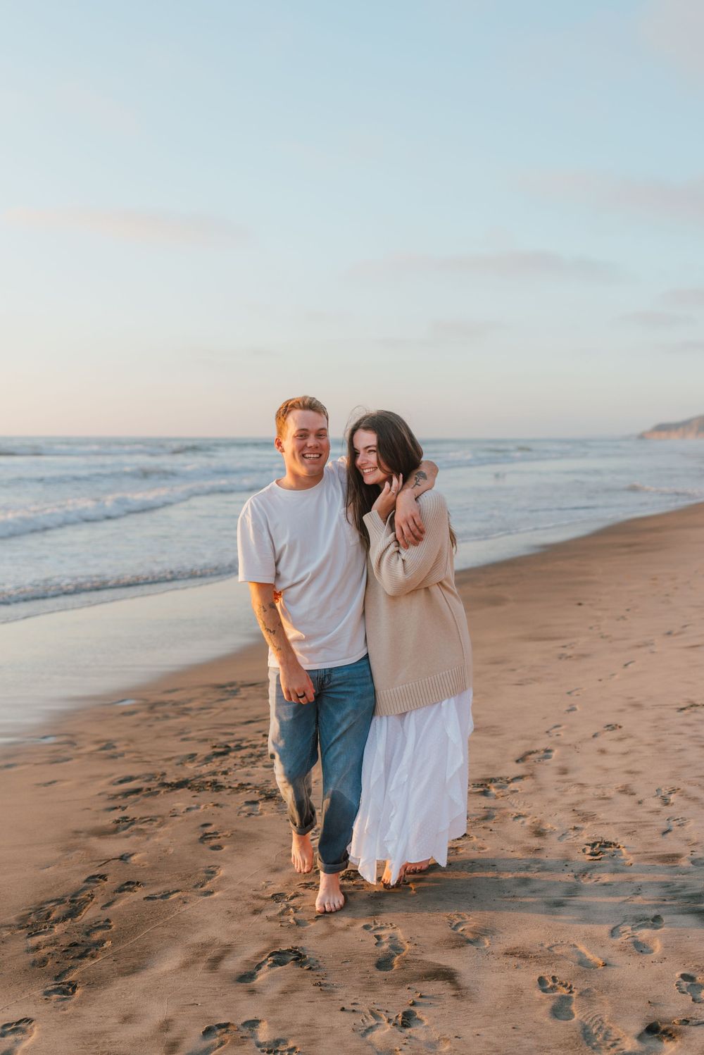 Blacks Beach couples photos with candid movement and dramatic coastal views, San Diego Engagement Photos