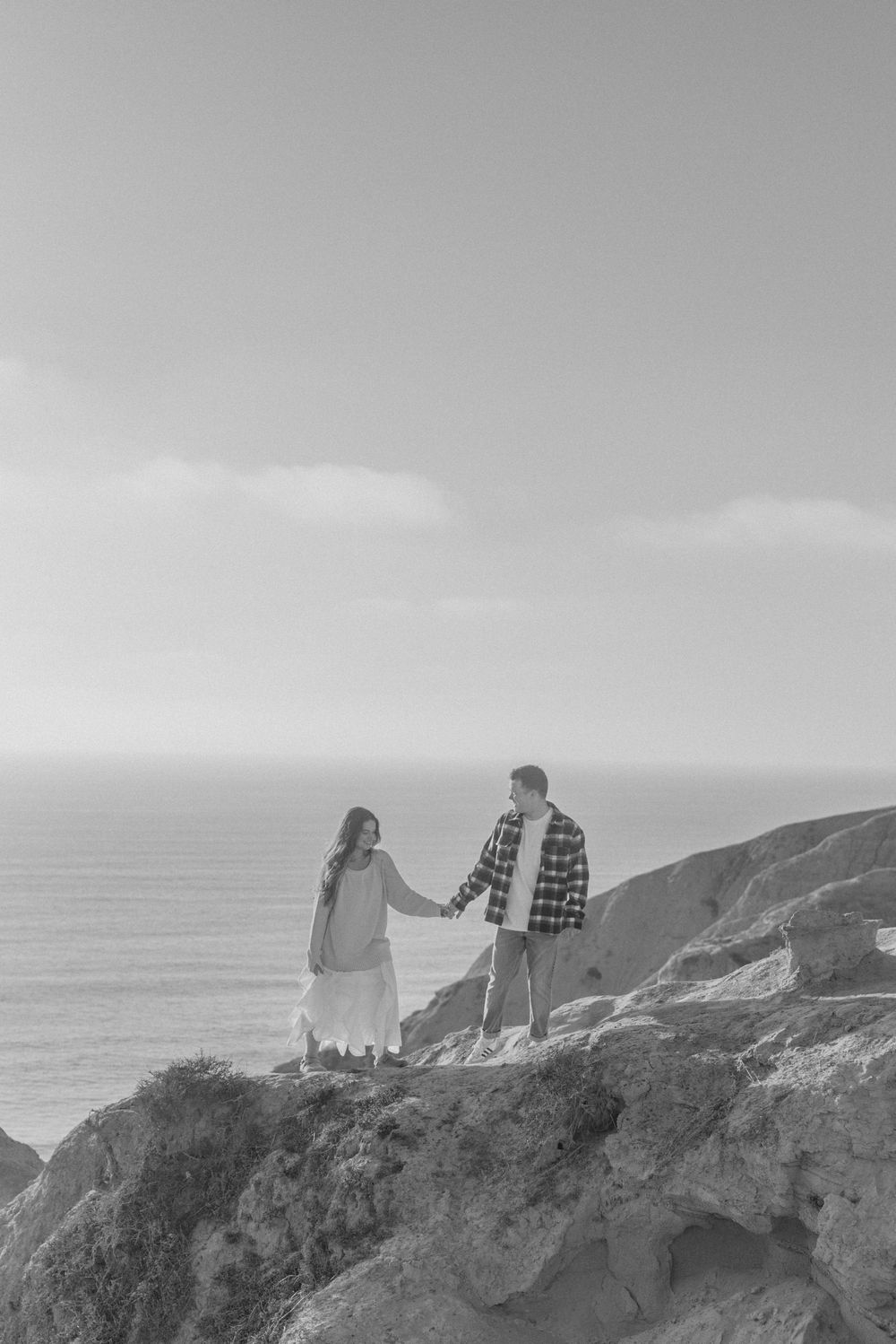 Blacks Beach couples photos with candid movement and dramatic coastal views, San Diego Engagement Photos