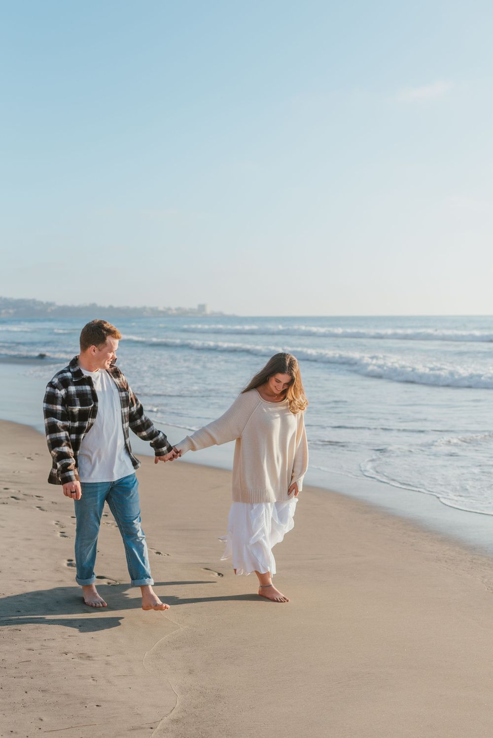 Blacks Beach couples photos with candid movement and dramatic coastal views, San Diego Engagement Photos