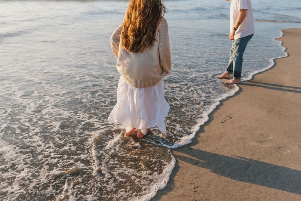 Blacks Beach couples photos with candid movement and dramatic coastal views, San Diego Engagement Photos