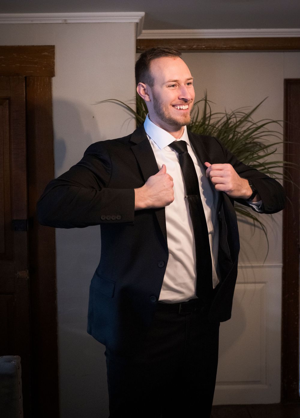 A sequence showing a person in formal attire dancing energetically at an indoor event.