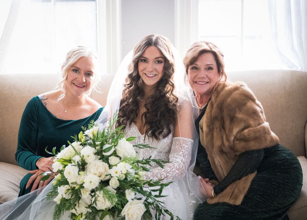 Beautiful bridal portrait featuring white floral bouquet and elegant lace gown.