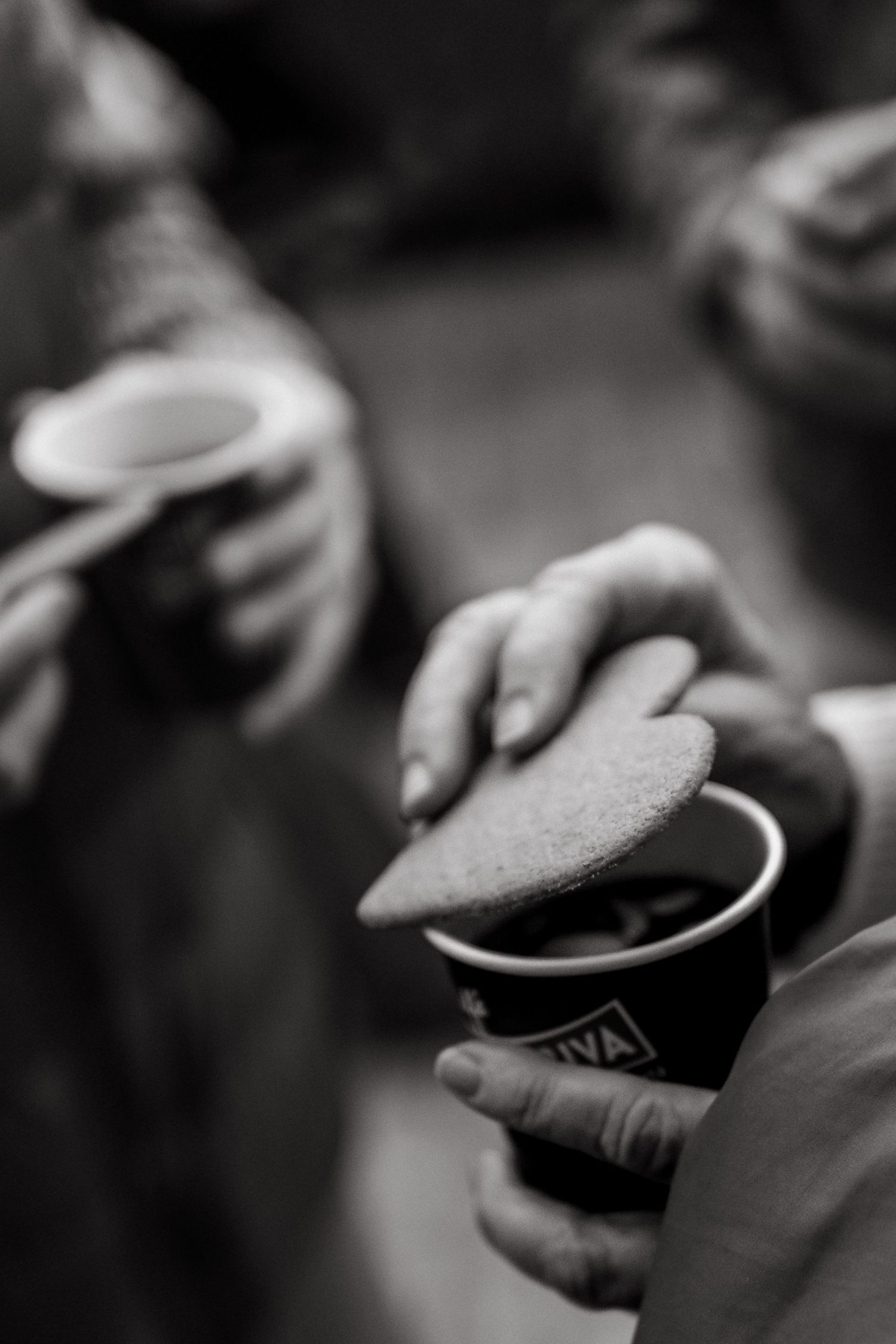 detail of woman's hand holding gingerbread cookie and hot wine during Christmas photoshoot in Stockholm for tourists