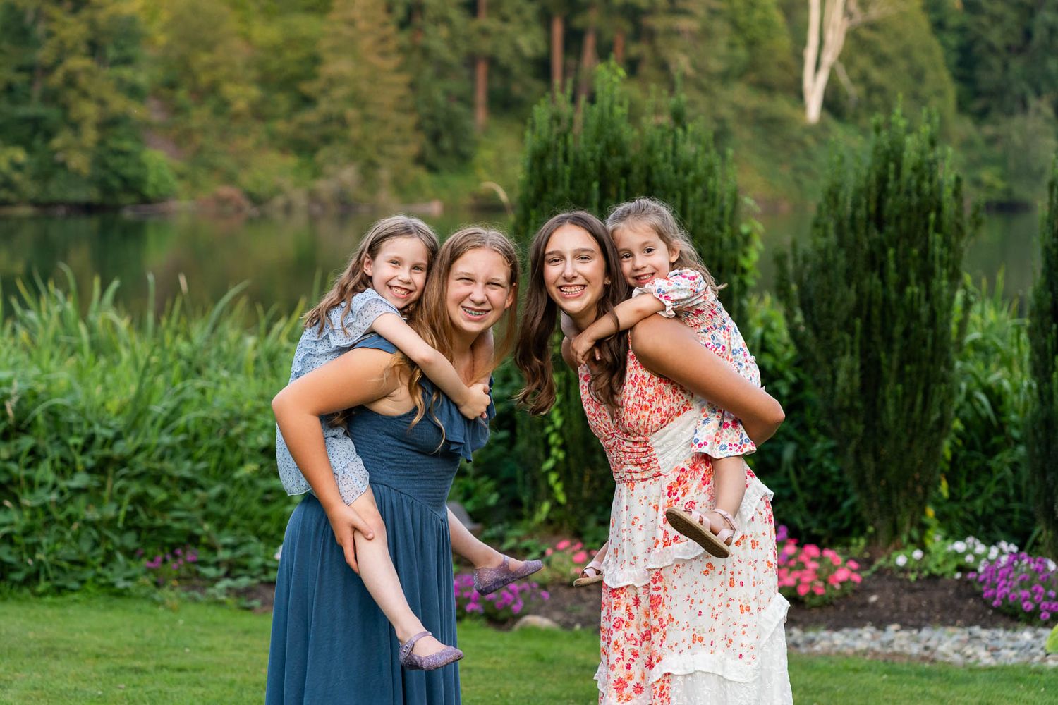 Grandchildren pose for a photo in front of flowers at Lake Wilderness Arboretum.