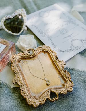 Vintage-style gold frames and delicate wedding stationery details.