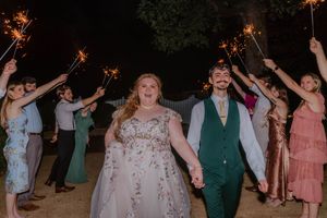 Sparkler exit celebration at night with guests lining up outside.