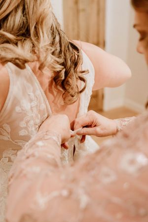 Close-up detail of delicate lace on a white wedding dress.