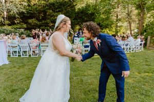 Joyful moment captured during outdoor wedding ceremony with natural garden backdrop.