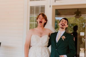A joyful wedding couple shares a laugh during their ceremony.