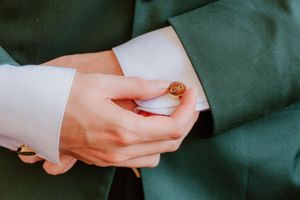 Close-up of hands exchanging wedding rings during a ceremony.
