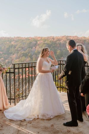 Wedding ceremony on scenic overlook with mountain views and autumn foliage.