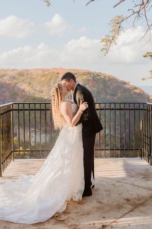 Couple sharing first look moment on mountain overlook during fall wedding.