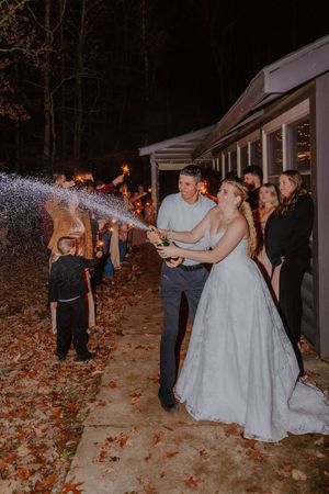 Wedding reception celebration at night with sparklers and joyful dancing.