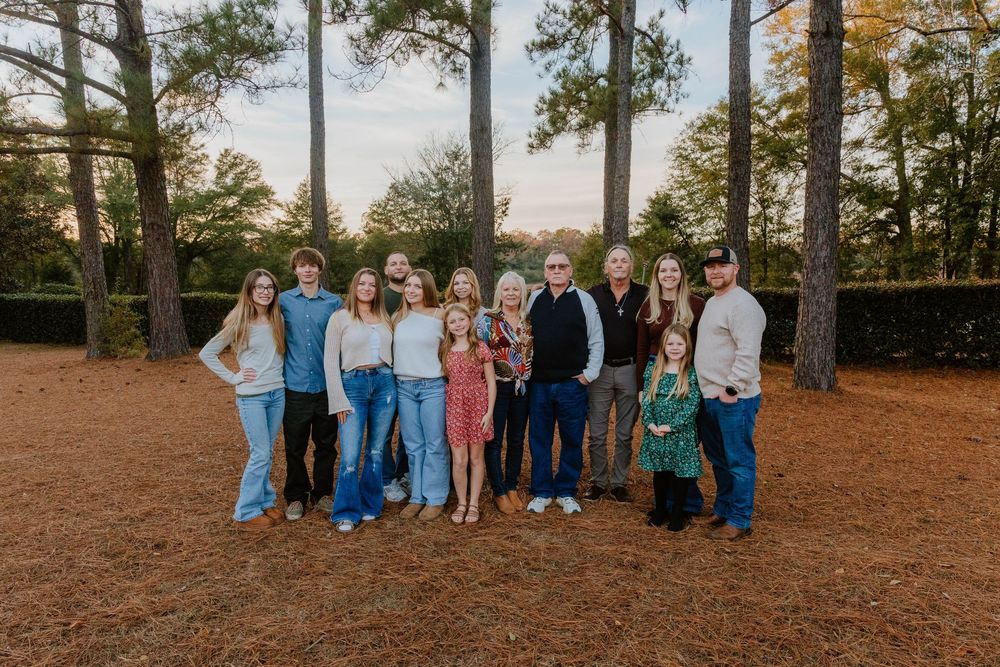 Extended family portrait session in a wooded area during golden hour.