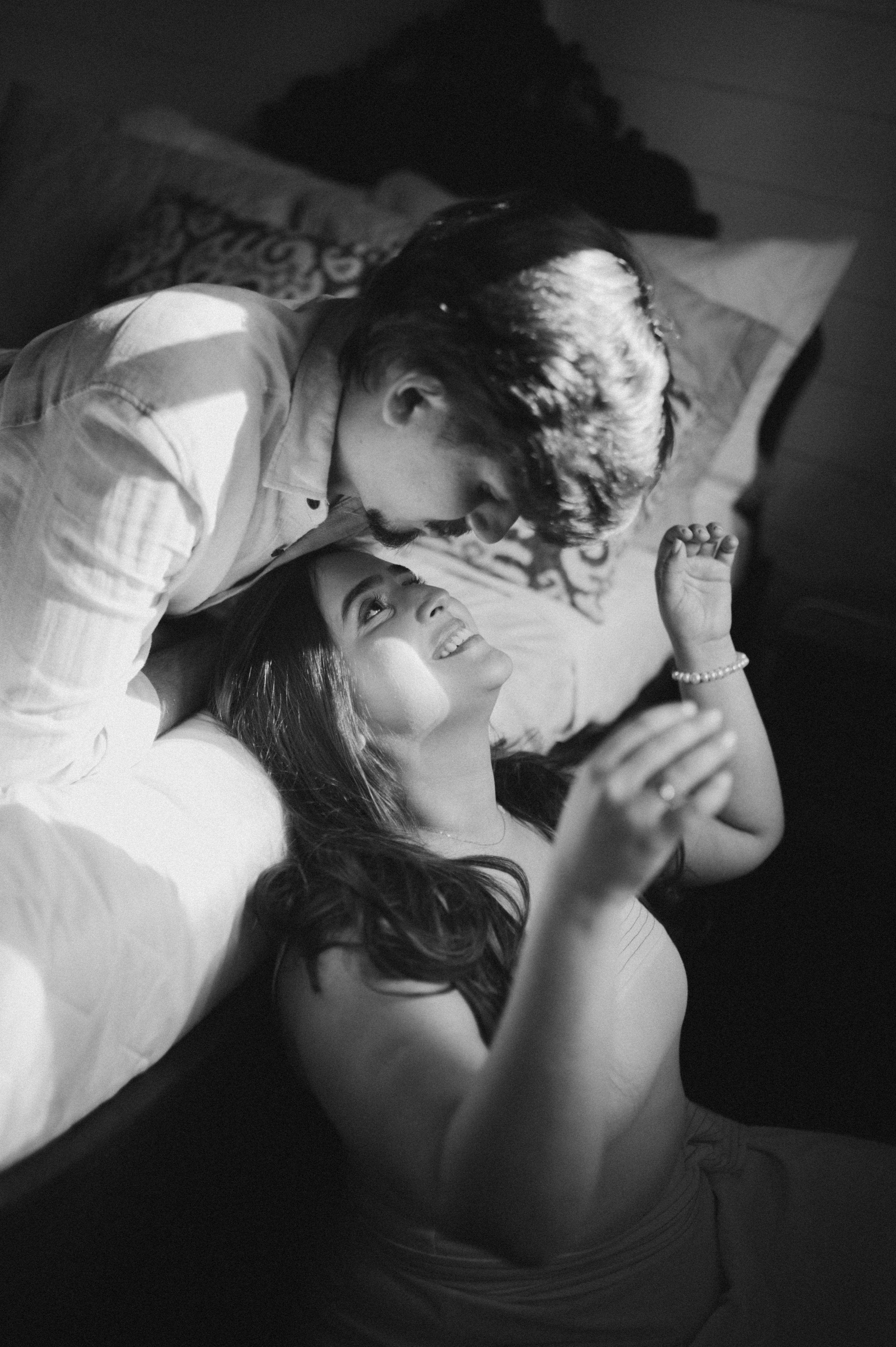 Artistic black and white photo of a tender intimate moment between a couple.