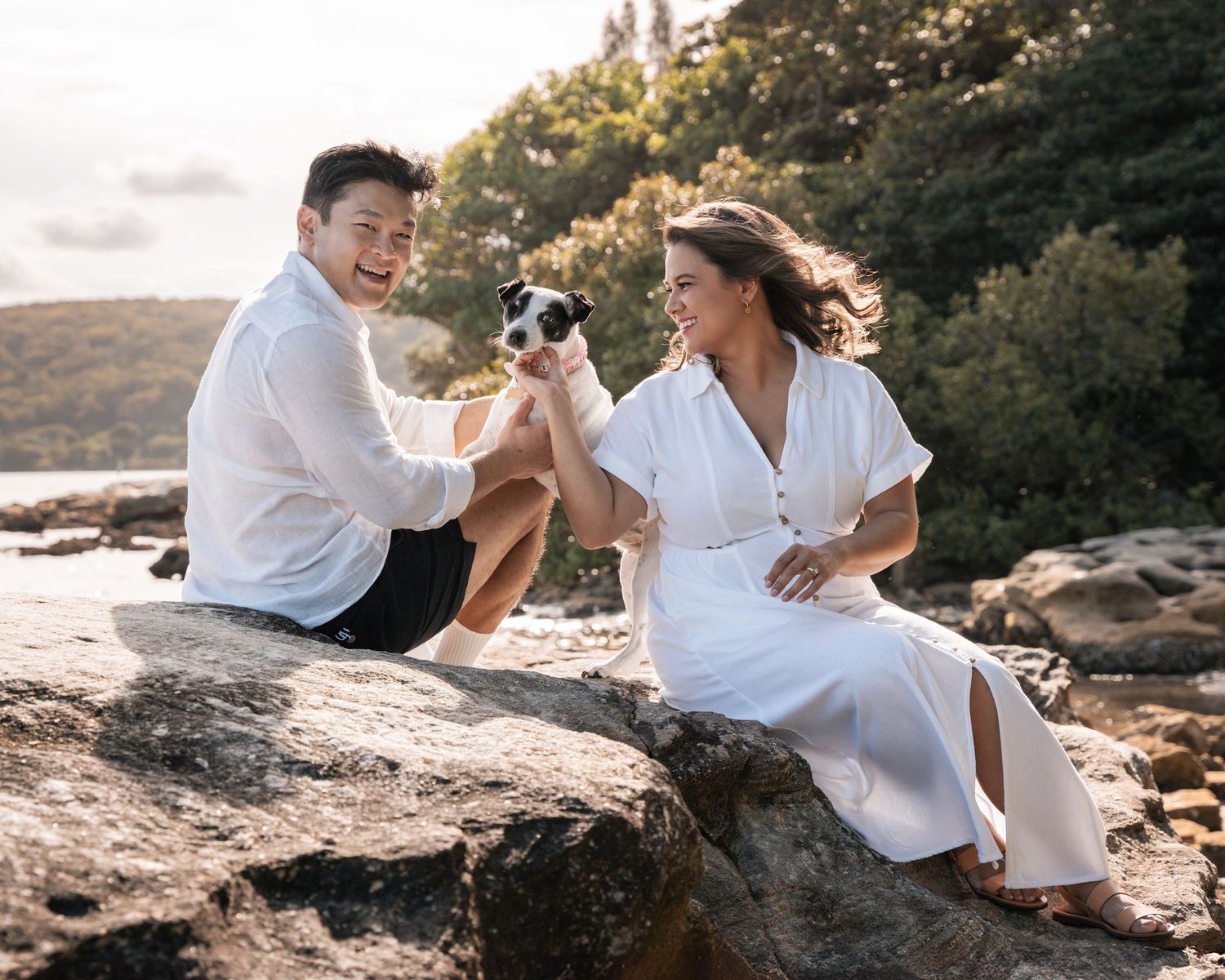 Professional couples photoshoot with a dog in Sydney during a golden hour time near the sea in a beautiful park