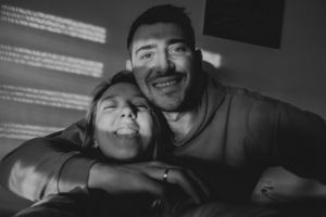 Two people sharing a joyful moment together in black and white photography.