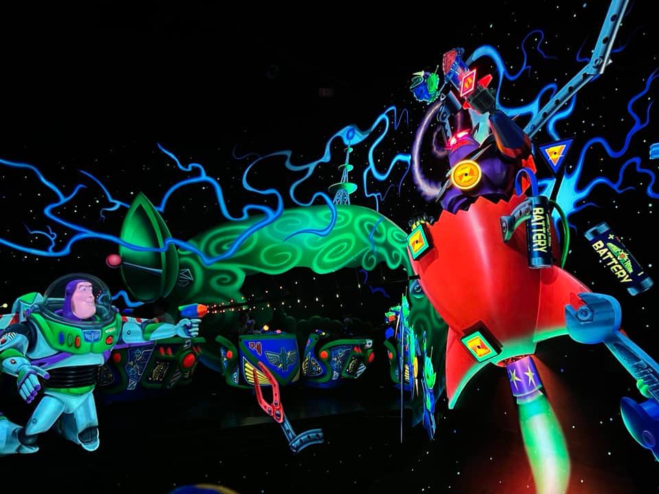 Vibrant swirling 3D abstract art patterns in neon colors against a black background show flowing digital elements.