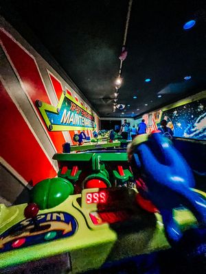 Close-up views of bowling alley lanes and pins at night with neon lighting effects creating a dynamic atmosphere.