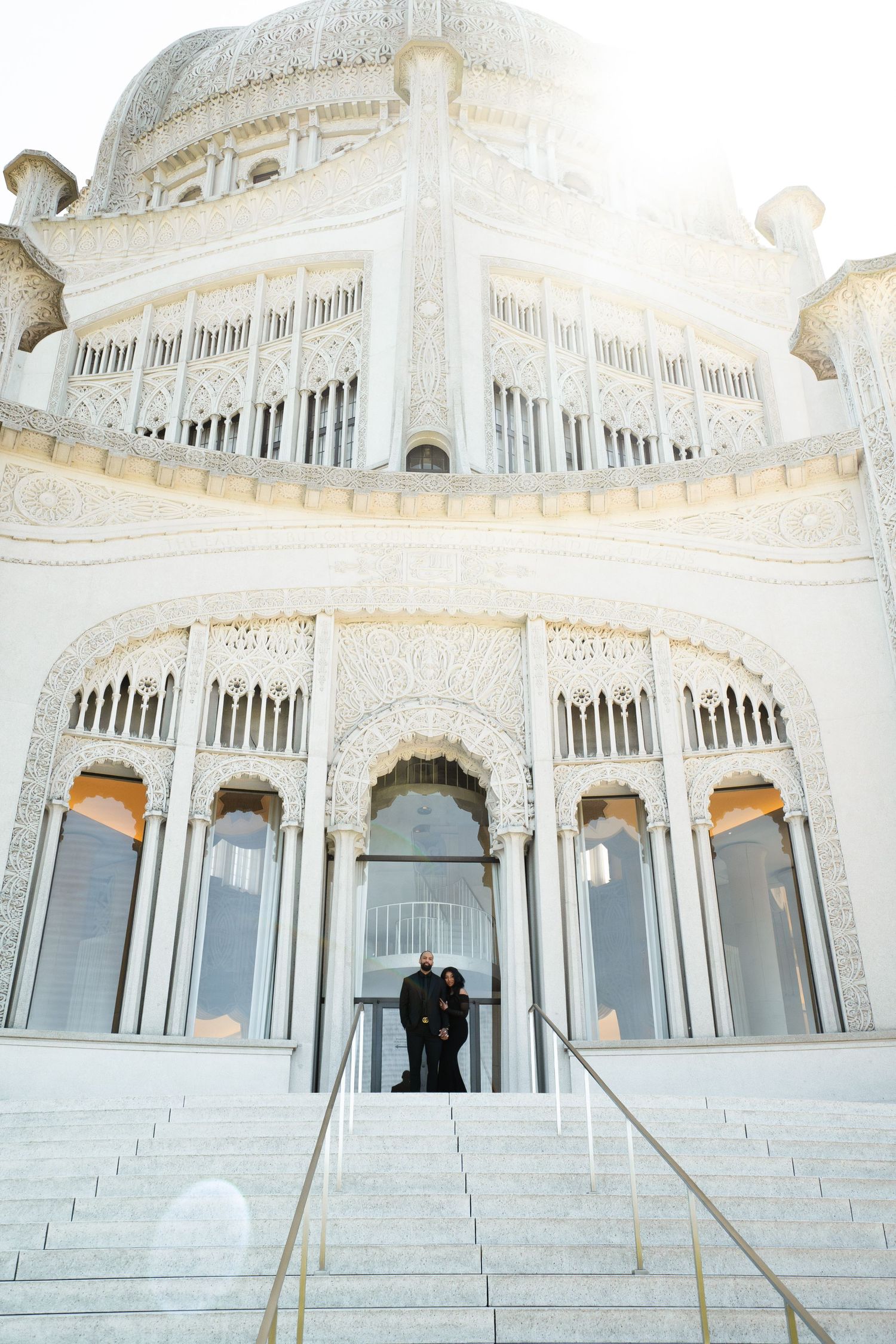 Ornate white temple architecture with grand steps and arched windows.
