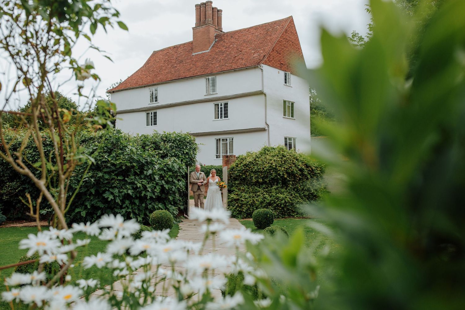 White country house provides romantic backdrop for wedding ceremony. Houchins wedding venue