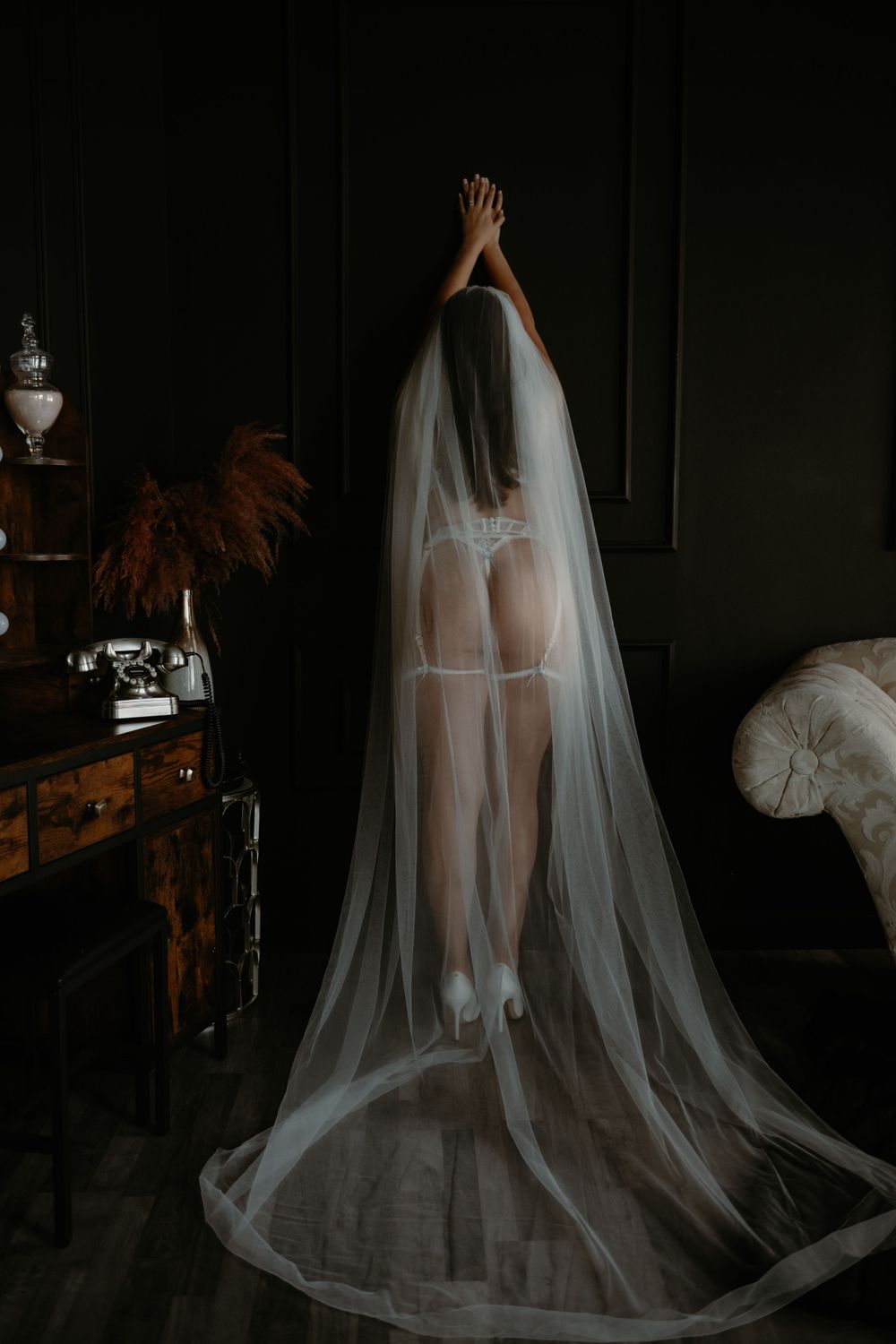 Woman embracing self-love during her Sweet Confidence Boudoir photo session for a bridal present.