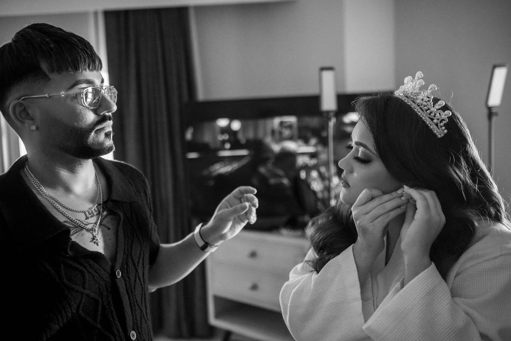 A black and white candid moment during wedding preparations.