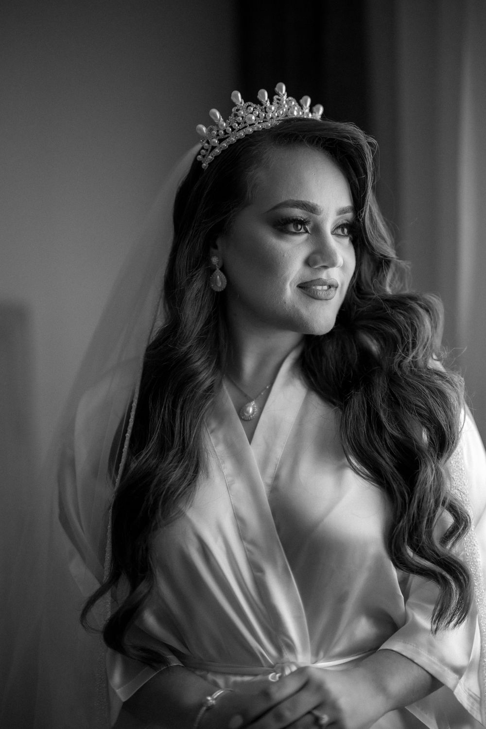 Classic black and white bridal portrait with tiara and flowing waves.