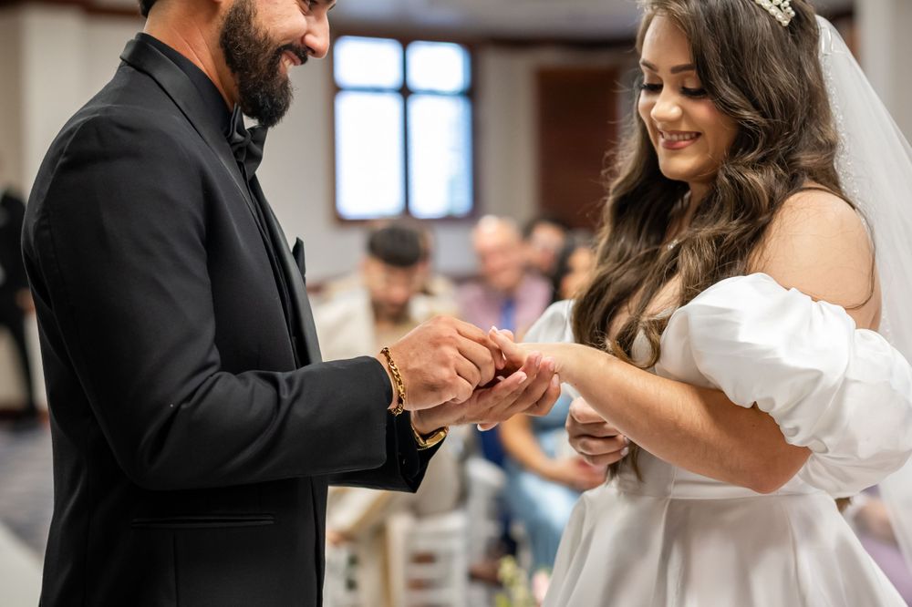 A wedding ceremony captured during the ring exchange moment.