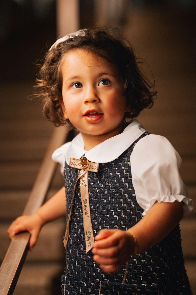 child walking down the iconic Sydney Opera House stairs during a family photoshoot, capturing a candid moment