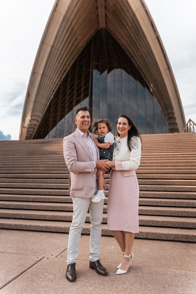Family standing in front of the iconic Sydney Opera House during a family photoshoot