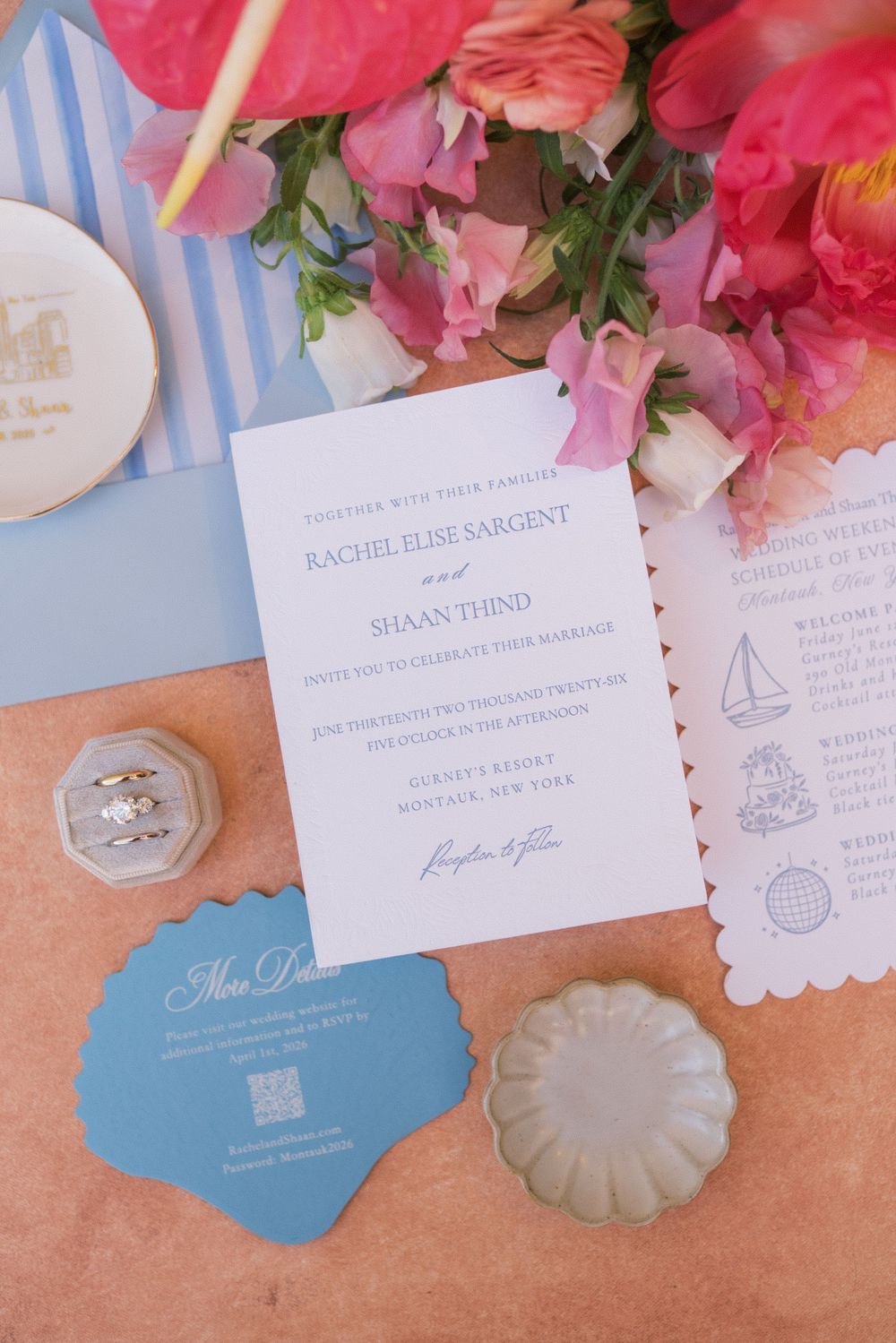 Elegant wedding invitation suite for Rachel Elise Sargent and Shaan Thind with pink florals, blue stationery, and a diamond ring.