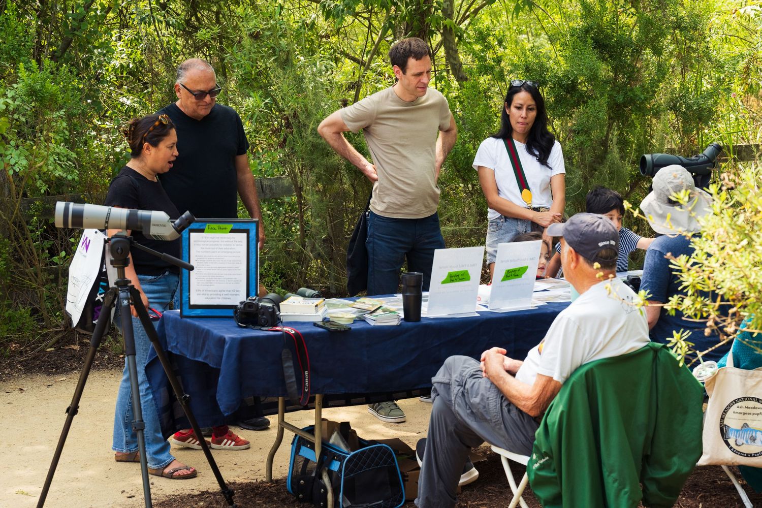 An event photo of volunteers with friends of balloon explaining to visitors the native birds during the Migration Event.