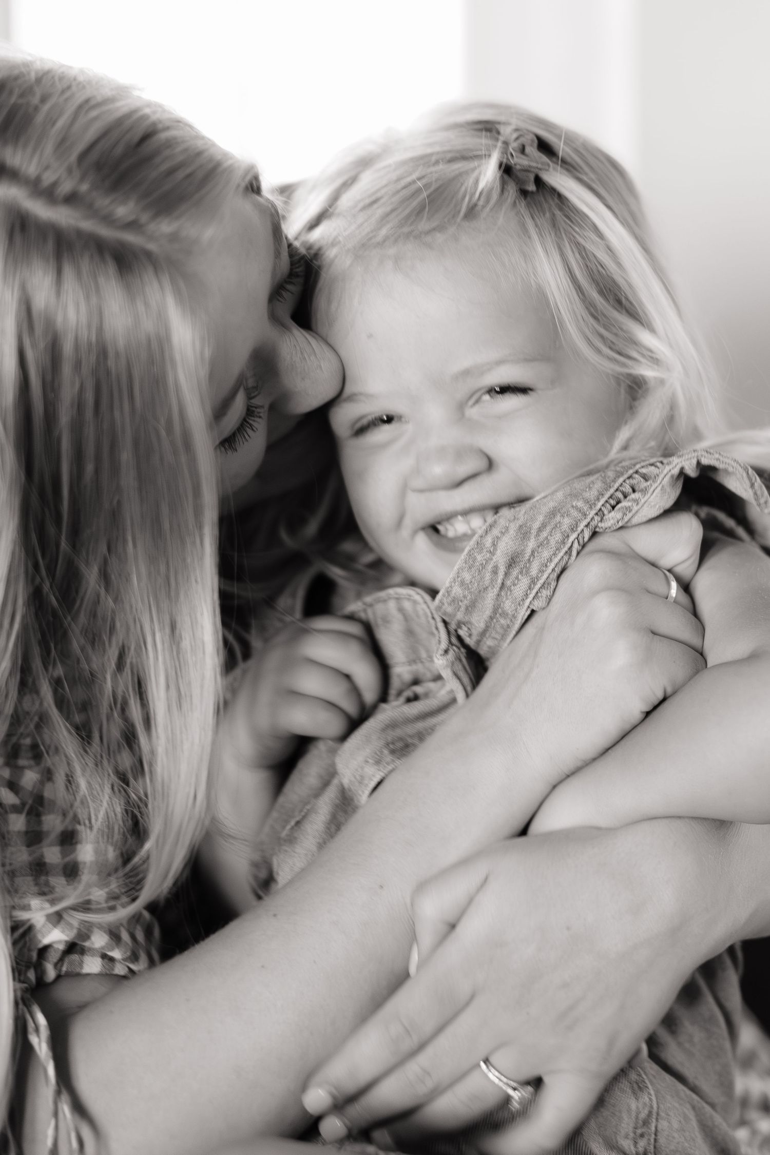 mom kissing laughing toddler