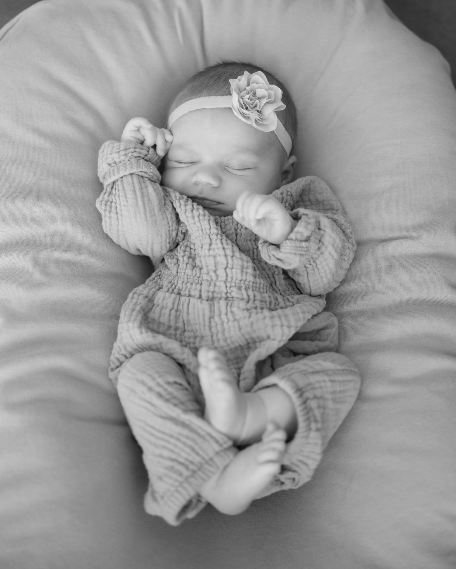 newborn baby doing the newborn scrunch during in home lifestyle newborn session in lake elmo, mn