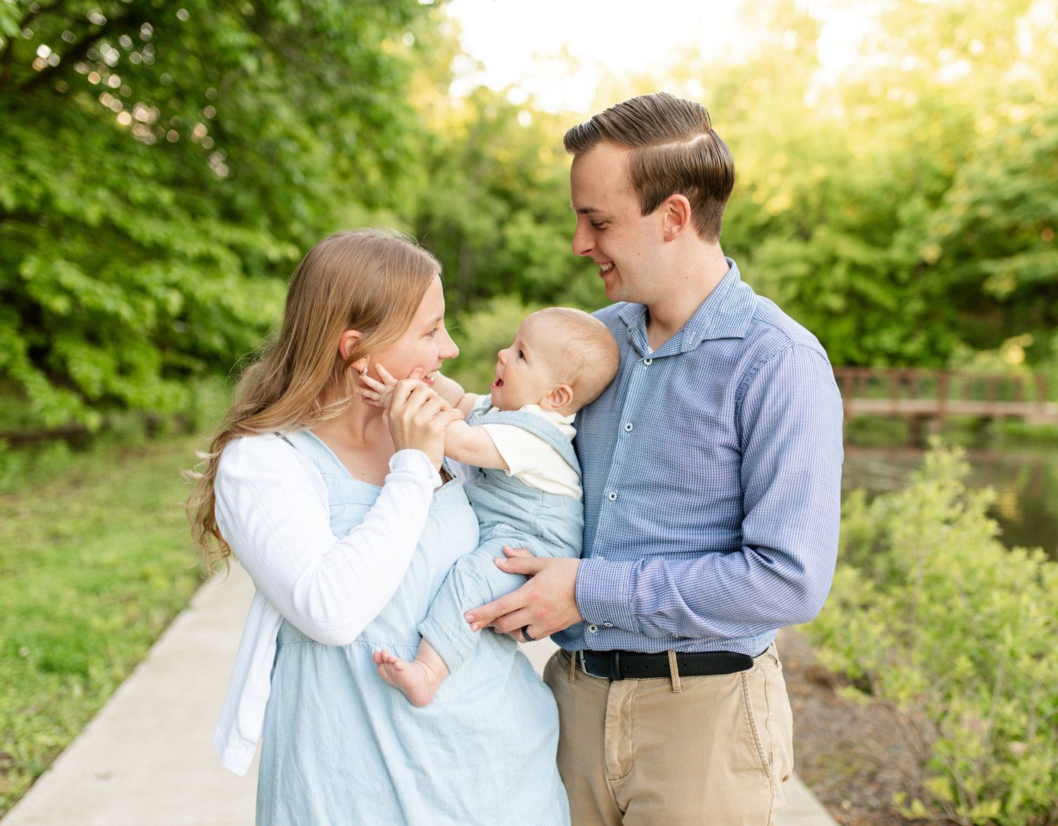 Parents laughing with their children during family photo session in O’Fallon MO