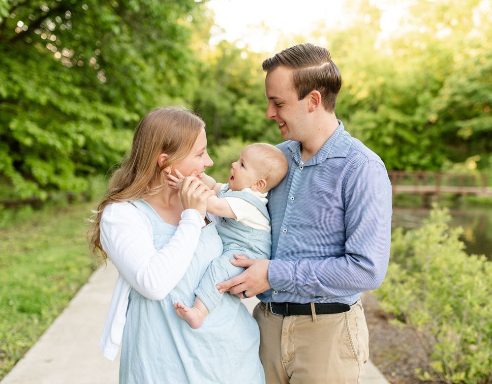 Parents laughing with their children during family photo session in O’Fallon MO