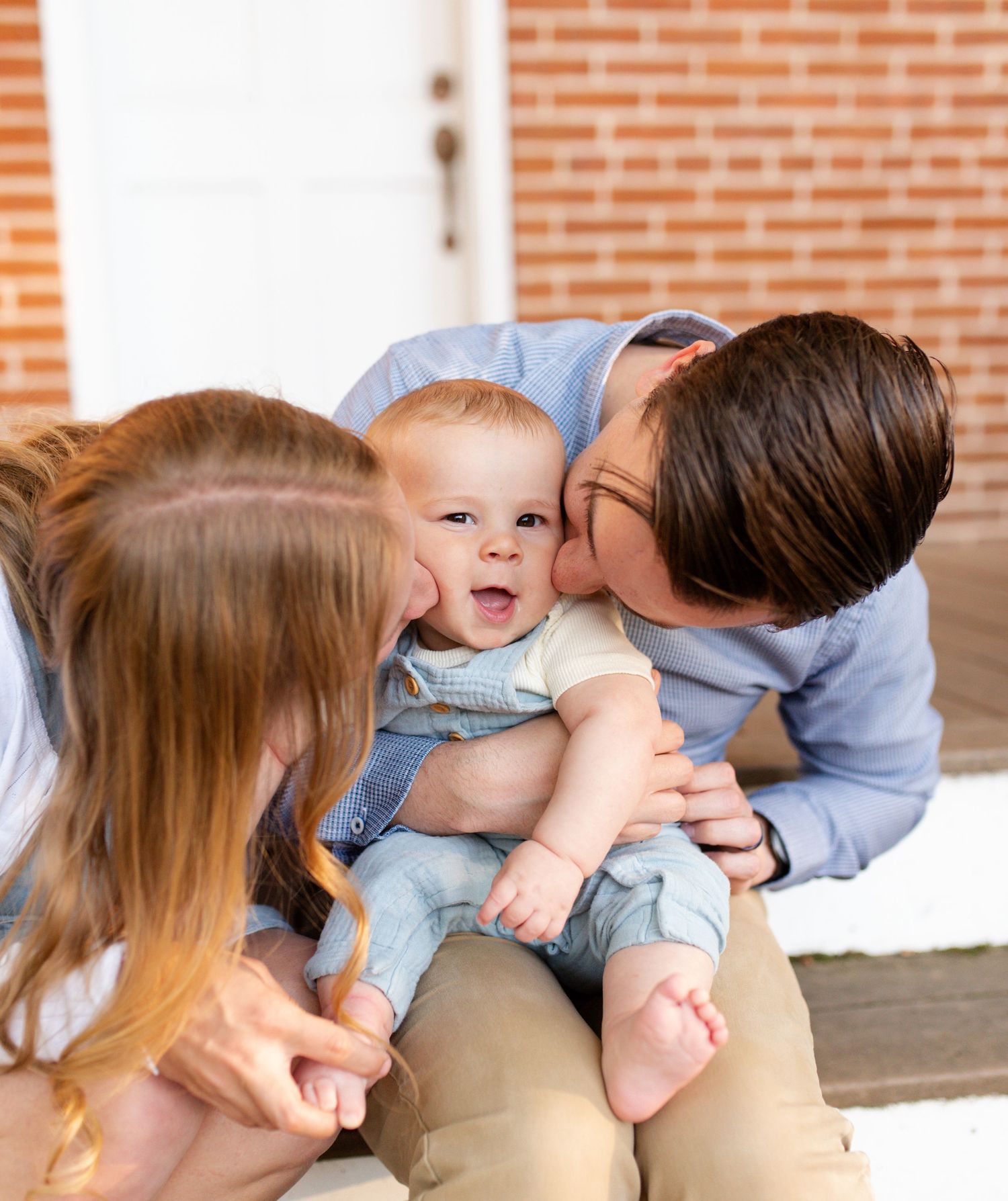 Mother and father playing with their children during golden hour photos in St. Charles County