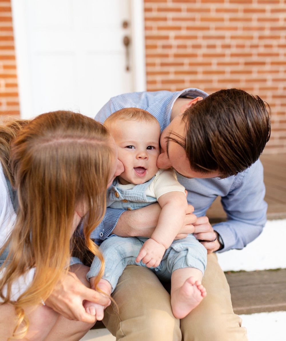 Mother and father playing with their children during golden hour photos in St. Charles County